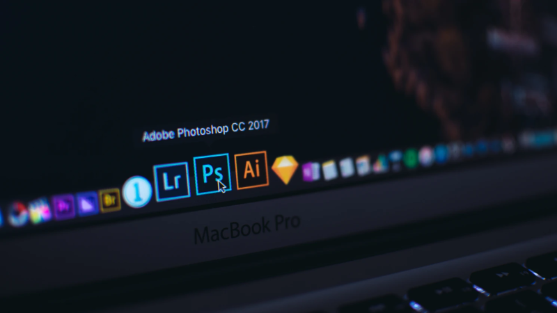 Adobe Lightroom and Adobe Photoshop apps open on a MacBook Pro