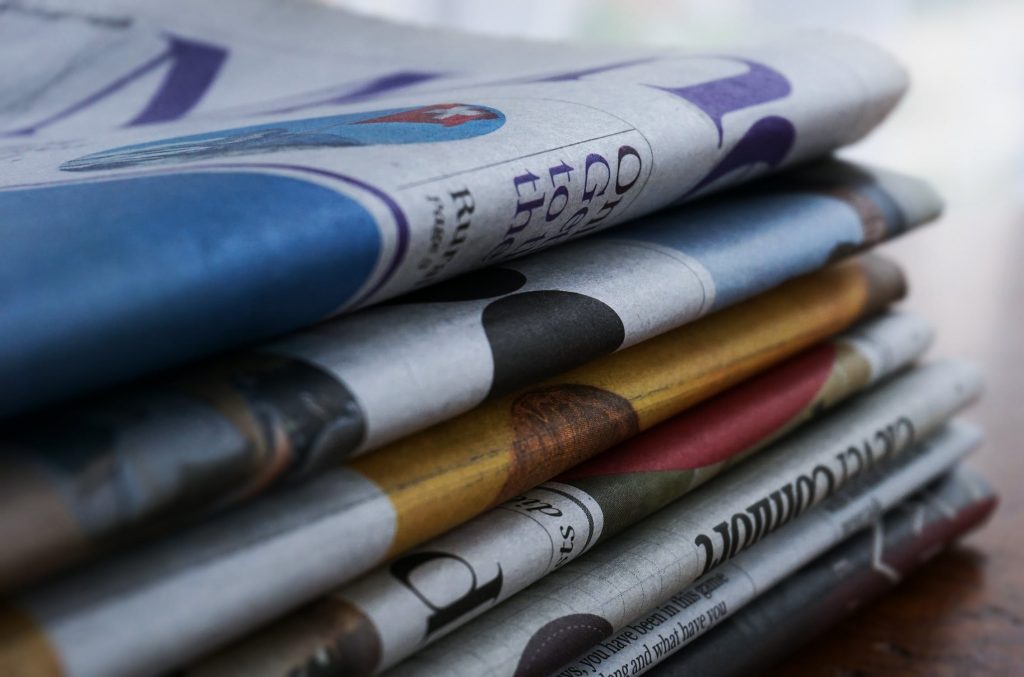 a stack of newspapers representing online animation news sites