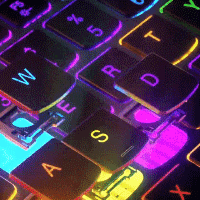 gaming pcs for animation keyboard with the keys lifted and shining yellow blue and pink