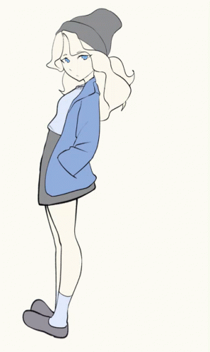 a girl standing on her heels wearing a beanie and a skirt and blazer which is blowing in the wind 