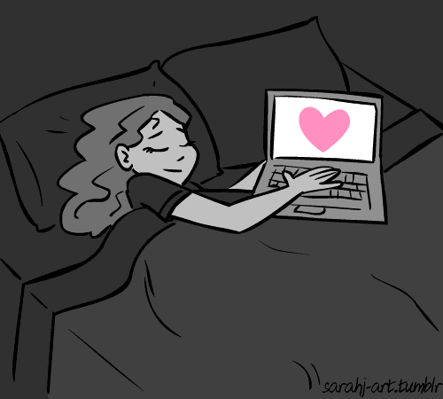 girl sleeping in her bed with her hands on her laptop with a pink heart on the laptop screen pumping