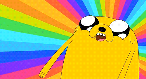 Jake the dog looking up with watery eyes and a rainbow spinning behind him