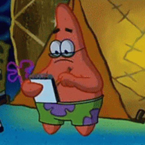 Patrick wearing glasses and concentrating on writing in a notepad