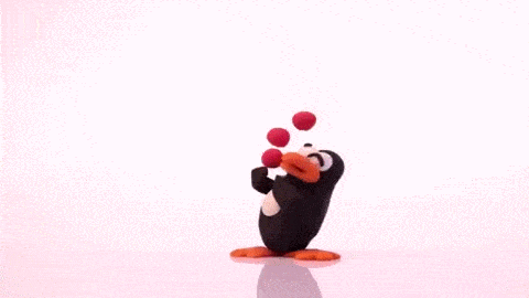 a penguin juggling red balls under studio lighting for stop motion animation