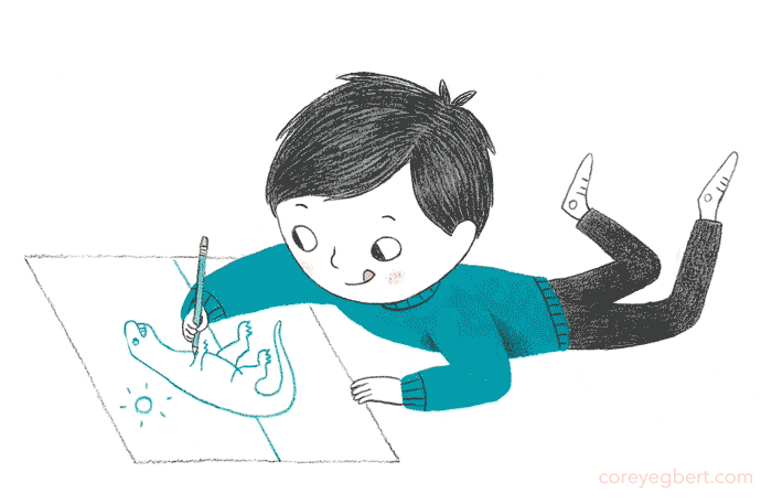 boy lying down moving his feet in the air and drawing a dinosaur on a piece of paper with his pencil and his tongue sticking out