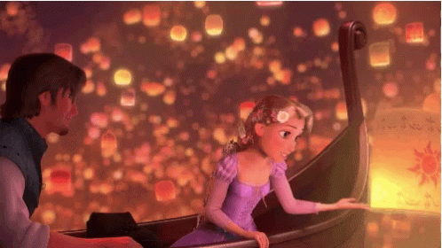 a scene from Tangled where Rapunzel is on a boat and lifts a sky lantern into the sky with many other lanterns at night